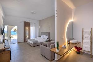 a bedroom with a bed and a couch and a table at Vivianna's View in Azolimnos Syros