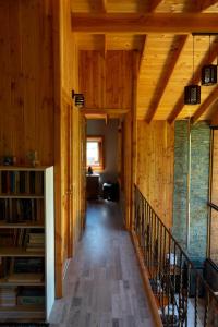a hallway of a house with wooden walls and a staircase at The GreeNest Lodge in Pucón
