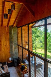 a living room with a large glass window in a cabin at The GreeNest Lodge in Pucón