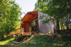 a cabin in the woods with stairs and trees at The GreeNest Lodge in Pucón