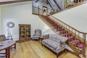 a living room with two chairs and a staircase at Halpino in Vicksburg