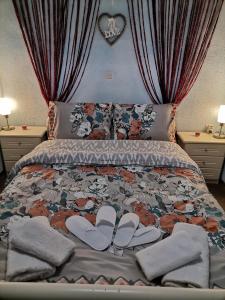 a bedroom with a bed with a pair of shoes on it at Frasta's Rose in Plaka