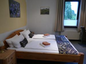 a bedroom with a bed with two towels on it at „Frische Quelle“ Jonsdorf in Kurort Jonsdorf