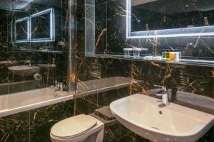 a bathroom with a sink and a toilet and a mirror at Best Western Hotel 99 in Blackburn +22 photos