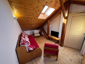 a view of a living room with a couch and a television at Charmant duplex pied de pistes Briançon in Briançon