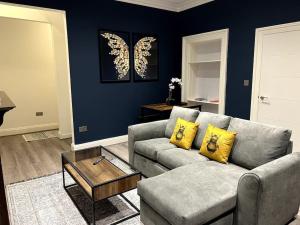 a living room with a couch and a table at Modern Cotham House by Prescott Apartments in Bristol