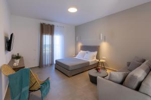 a bedroom with a bed and a living room at Vivianna's View in Azolimnos Syros