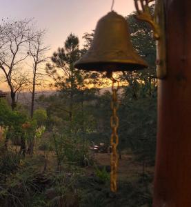 a bell hanging from the side of a building at Cabaña Las Nubes in Río Ceballos