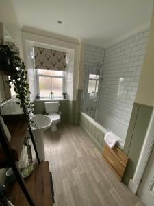 a bathroom with a toilet and a shower and a sink at Kilmory House in Lochgilphead