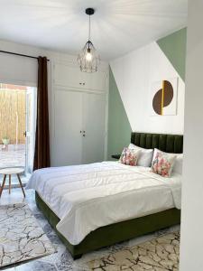 a bedroom with a large bed and a chandelier at Cosy appartement Next to Majorelle Garden in Marrakech