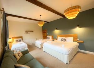 a living room with two beds and a couch at New Ing Lodge in Shap