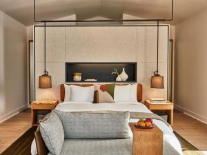 a bedroom with a large bed and a couch at Solage, Auberge Resorts Collection in Calistoga
