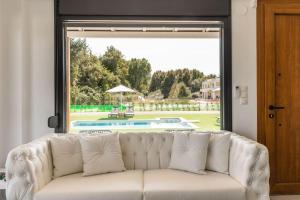 a white couch in a living room with a large window at Lobster in Leptokaria