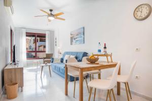a living room with a table and a blue couch at RELAX JANDIA in Morro del Jable