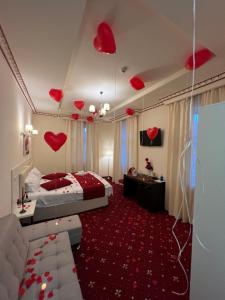 a bedroom with hearts hanging from the ceiling at Top Royal Central Brasov in Braşov