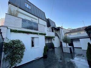 a white building with plants on the side of it at Studio in Livry-Gargan