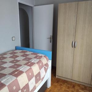 a bedroom with a bed and a cabinet at Apartamento Amezti in Elizondo