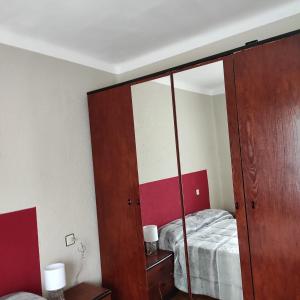 a bedroom with a bed and a large mirror at Apartamento Amezti in Elizondo