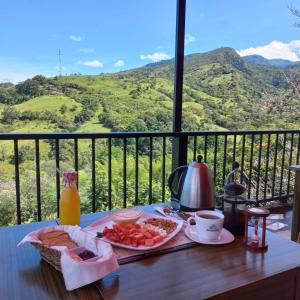 a breakfast table with a view of a mountain at MANIPURA in Guaduas +14 photos