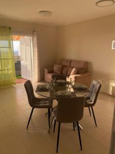 a living room with a table and chairs and a couch at Apartamento en Costa Adeje in Adeje