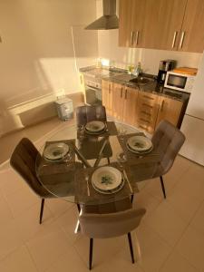 a kitchen with a glass table and chairs in a kitchen at Apartamento en Costa Adeje in Adeje