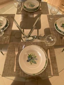 a table with plates and forks and glasses on it at Apartamento en Costa Adeje in Adeje