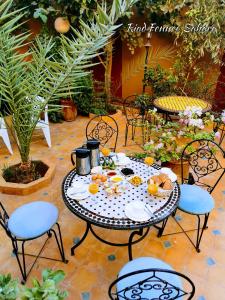 a table with fruits on it on a patio at Riad Fennec Sahara in Zagora