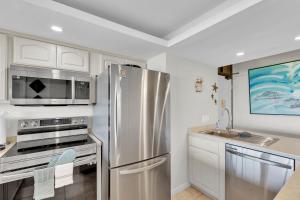 a kitchen with a stainless steel refrigerator and a sink at Sea Vista in South Padre Island