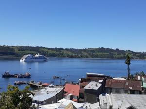 a cruise ship is docked in a large body of water at CABAÑAS REY-MAR in Castro