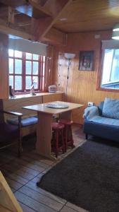 a kitchen with a table and a couch in a room at CABAÑAS REY-MAR in Castro