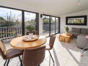 a living room with a table and chairs and a couch at Phoenix House in Castlemorton