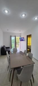 a dining room with a table and chairs at Departamento Playa Sur in Mazatlán +11 photos