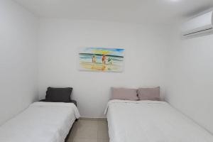 Llit o llits en una habitació de Departamento Playa Sur