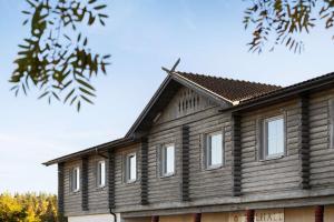 a wooden house with white windows on it at Sure Hotel by Best Western Dalhall in Åmål