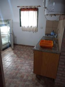 a kitchen with a stove and a counter top at Cabaña en quinta la aurora in Mina Clavero