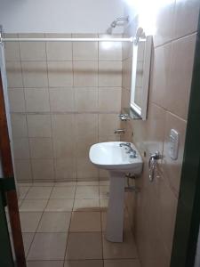 a small bathroom with a sink and a mirror at Cabaña en quinta la aurora in Mina Clavero +43 photos
