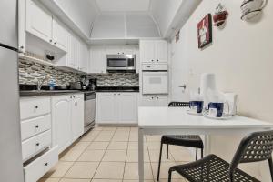 a kitchen with white cabinets and a table and chairs at THE TIDES 1bedroom apt 4th floor WE ARE ON THE BEACH! in Hollywood