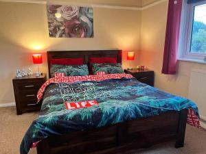 a bedroom with a bed with red pillows at North Wales Holiday Accomodation with Free parking & WiFi in Bodelwyddan