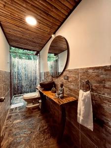 a bathroom with a sink and a mirror at Glamping Salento con jacuzzi climatizado in Salento