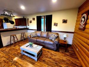 a living room with a couch and a table at KM Ranch Hideaway Cabin in Whitefish