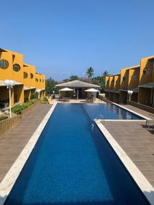 uma piscina com água azul num resort em Condomínio Imbassai Summer Flat em Imbassaí