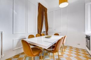 a dining room with a white table and chairs at NEW!! SPAGNA Suite - Your Italian Holidays in Rome
