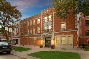 a brick building with a car parked in front of it at Adorable 1BR Apt in Evanston with Onsite Laundry - Elmwood 105 in Evanston