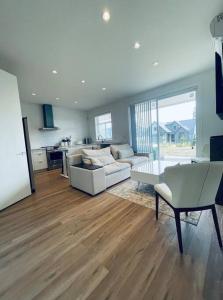 a living room with a couch and a table at Gorgeous 3 bedroom lake house Suite! in Shawnigan Lake