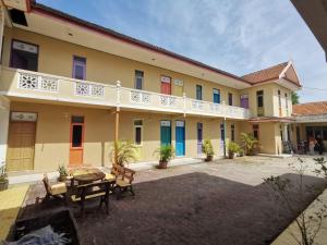 a courtyard of a building with a table and chairs at RVH Kuala Terengganu in Kuala Terengganu