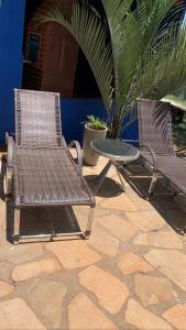 two chairs and a table on a patio at Chacara vila geovana suites in Pirenópolis