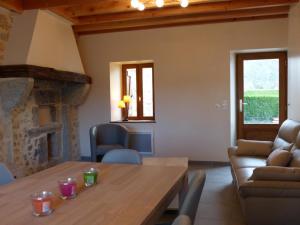 a living room with a wooden table and a couch at Gîte La Guillermie, 4 pièces, 6 personnes - FR-1-489-140 in La Guillermie