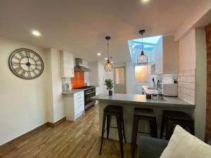 a kitchen with a large island in the middle at Nice Living Serviced Accommodations 2 in Coventry