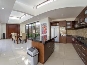 a large kitchen with a counter and a table at Villa Uma Girasole in Canggu