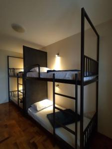 a room with three bunk beds in a room at Soul Hostel Av Paulista Bela Vista 2 in São Paulo